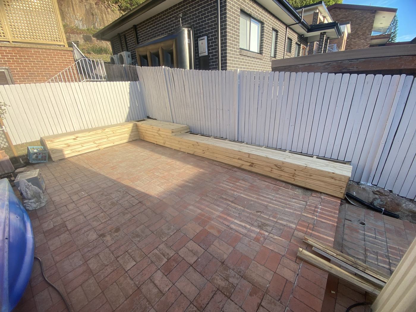 Built-in pine seating along the fence